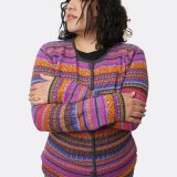 Woman wearing striped alpaca cardigan - arms crossed buttoned