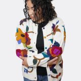 Woman wearing open alpaca floral cardigan - arms crossed